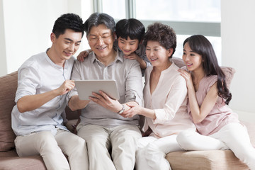 Fototapeta premium Happy family looking at photo album