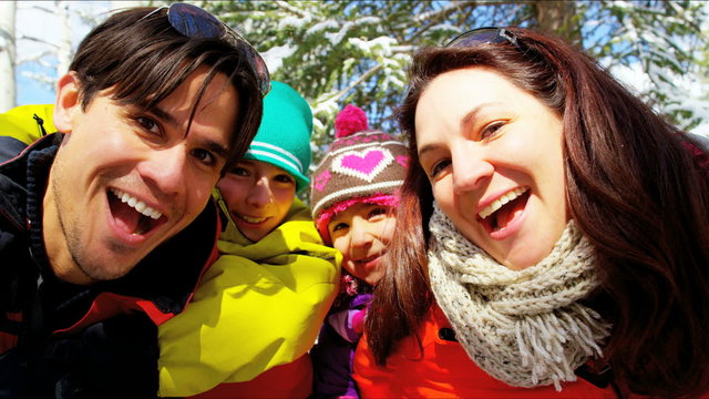 portrait snow outdoor lifestyle Caucasian family travel tourism promotion 