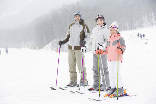 Young family skiing in ski resort
