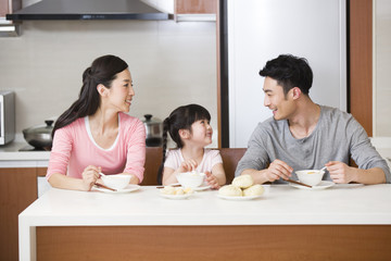Obraz na płótnie Canvas Happy family having breakfast