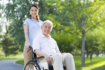 Wheelchair bound man with nursing assistant