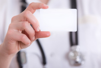 Female doctor showing blank business card