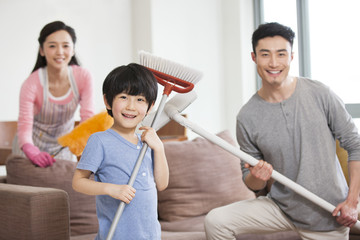Fototapeta premium Cheerful family doing chores at home