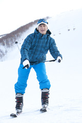 Fototapeta na wymiar Young man in skiing resort