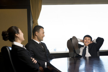 Three business professionals relaxing