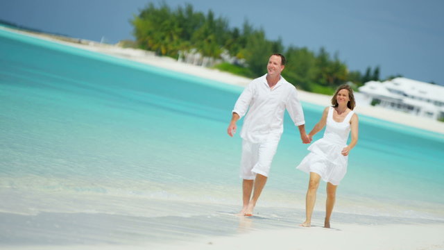 healthy outdoor lifestyle Caucasian couple achievement success beach resort