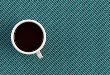 Obraz na płótnie Canvas Coffee cup on blue fabric table