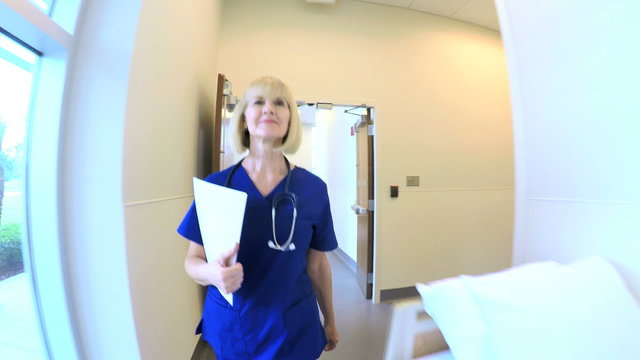 Senior Caucasian American female doctor walking corridor in hospital