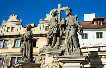 Fototapeta na wymiar Savior and holy Cosmas and Damian statue on the Charles Bridge in Prague