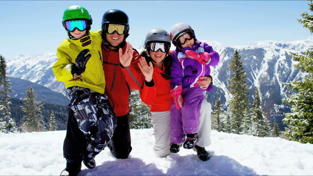 portrait winter skiing vacation Caucasian family parents children snow resort