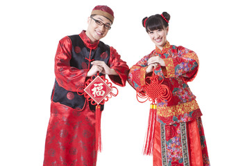 Young couple in traditional Chinese clothing greeting for Chinese New Year