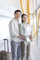 Mature couple waiting at airport