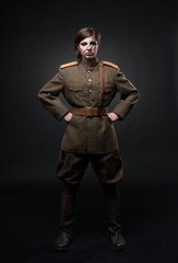 Fototapeta na wymiar Sexy woman in military uniform. Studio shot. Black background