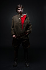 Obraz premium Sexy woman in military uniform. Studio shot. Black background