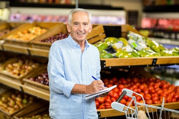 Smiling senior man with shopping list 