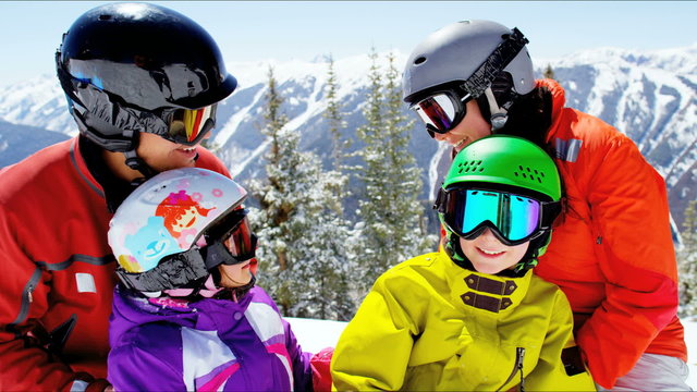 portrait Caucasian family parents children lifestyle snow mountains destination
