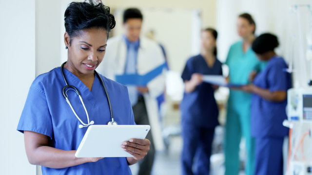African American female senior staff working on tablet technology in hospital