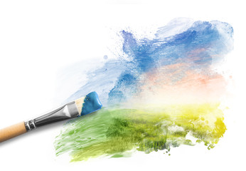 Obraz premium Painting the spring landscape. Brush with blue paint over sky and green field