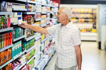 Senior man picking canned food 