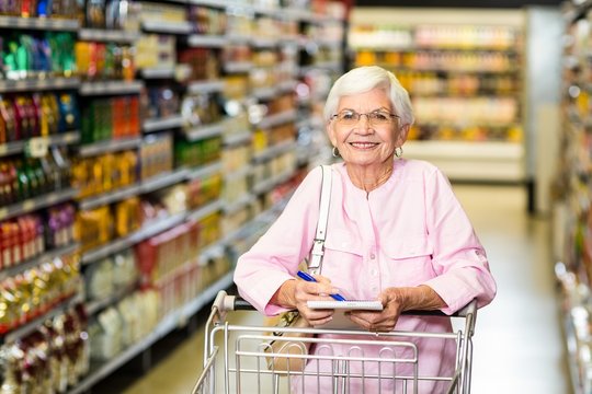 Smiling senior woman with grocery list