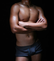 front view of the body of a hunky young asian in blue trunks