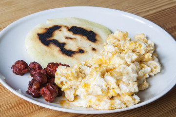 Venezuelan arepas with scrambled eggs and sausage