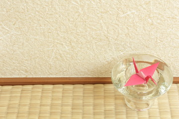 Red paper crane in a glass ornament