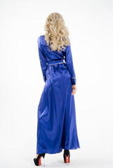 A woman in a blue, long gown on a white background