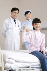 Fototapeta premium Portrait of a young and healthy girl and her doctor and nurse