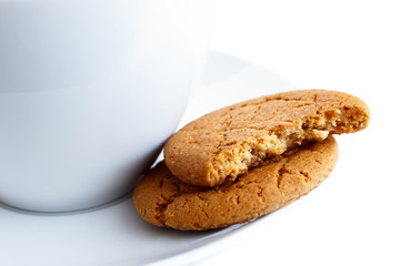 Ginger biscuits with cup and saucer.