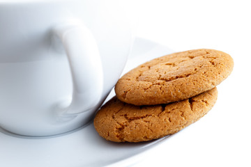 Ginger biscuits with cup and saucer.