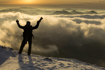 Fototapeta na wymiar Photographer on top of mountain over the clouds enjoying the vie