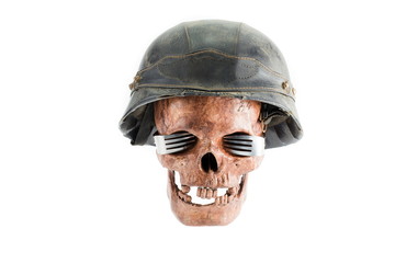 Skull with eyeglass by fork on white background