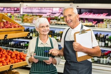 Senior colleagues with clipboard working 