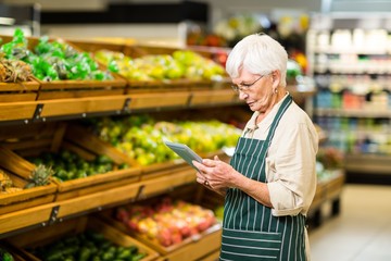 Senior employee working with tablet 