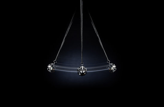 Hypnosis.
A silver pendulum swings on a dark background and symbolizes the hypnosis.

