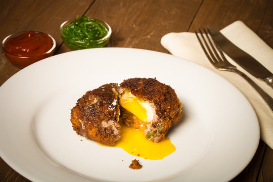 Fried cutlet  with egg inside served on a plate. Selective focus