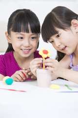 Obraz na płótnie Canvas Girls playing child's play clay