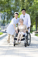 Doctor, nurse and wheelchair bound patient