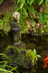 Meditation concept: monk statue in the pool. Vintage style 
