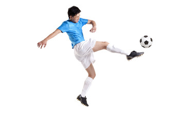 Naklejka na ściany i meble Soccer player kicking while jumping