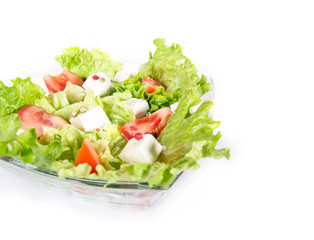 Green salad isolated on white. Close up of diverse vegetables