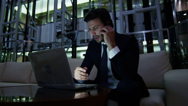 Caucasian European business male night developer traveller laptop smart phone