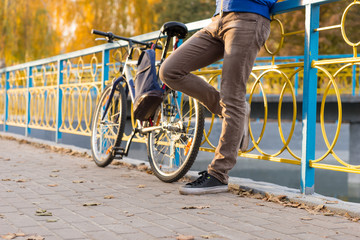 Man with Bike Taking Rest in Park on Autumn Day