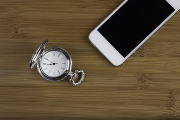 smartphone and pocket watch