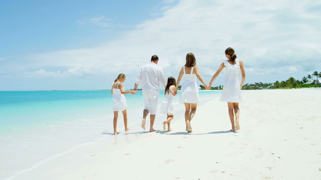 leisure travel promotion beach ocean Caucasian happy family parents young girls