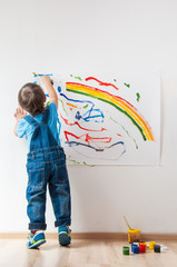 child draws ink on paper