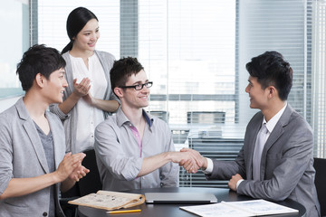 Business persons shaking hands for cooperation