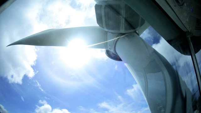 Wind turbine blades turning interior sunlight generating electricity Canada