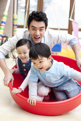 Happy kindergarten children and teacher playing games